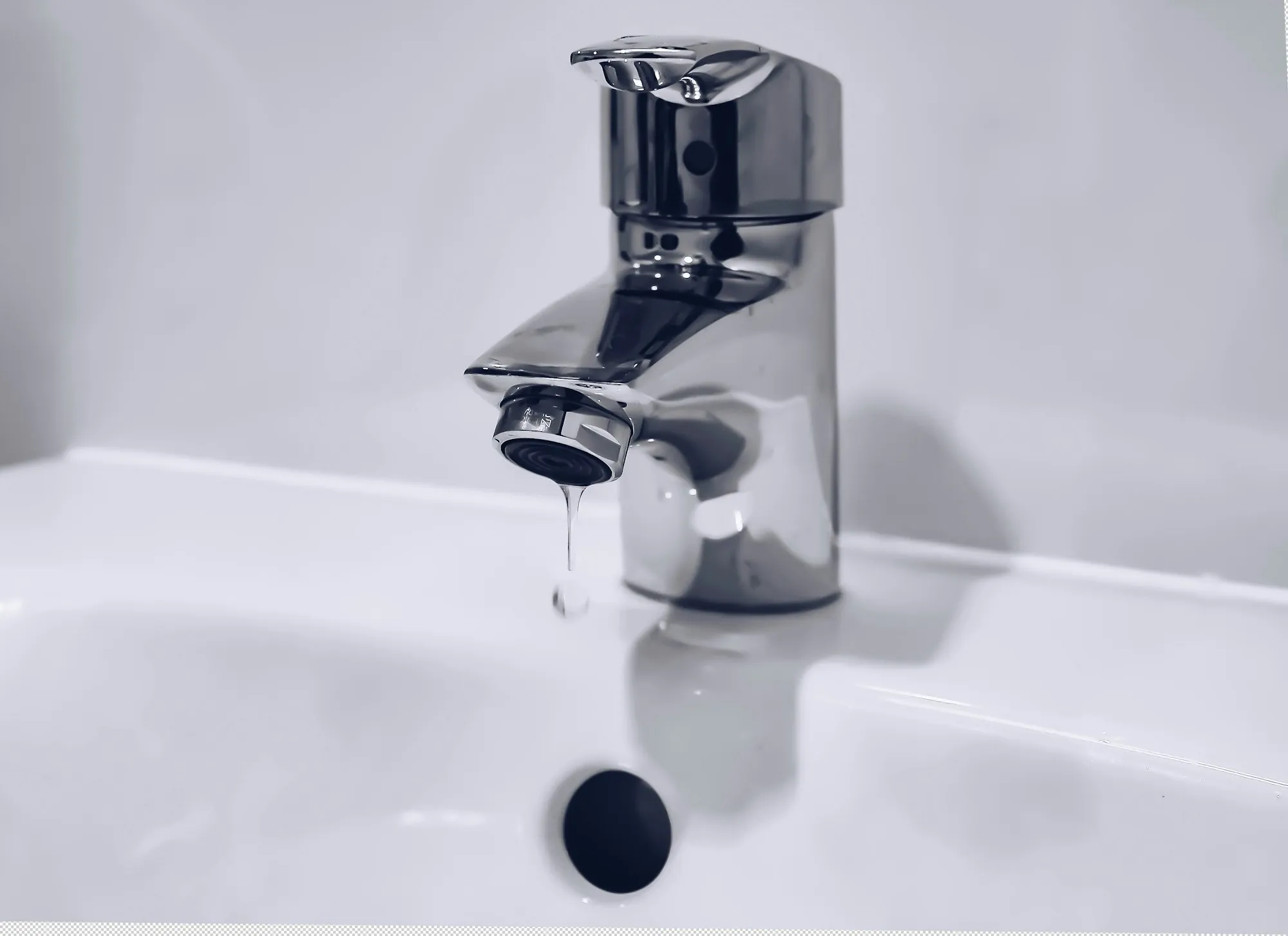 Chrome faucet running into a white basin