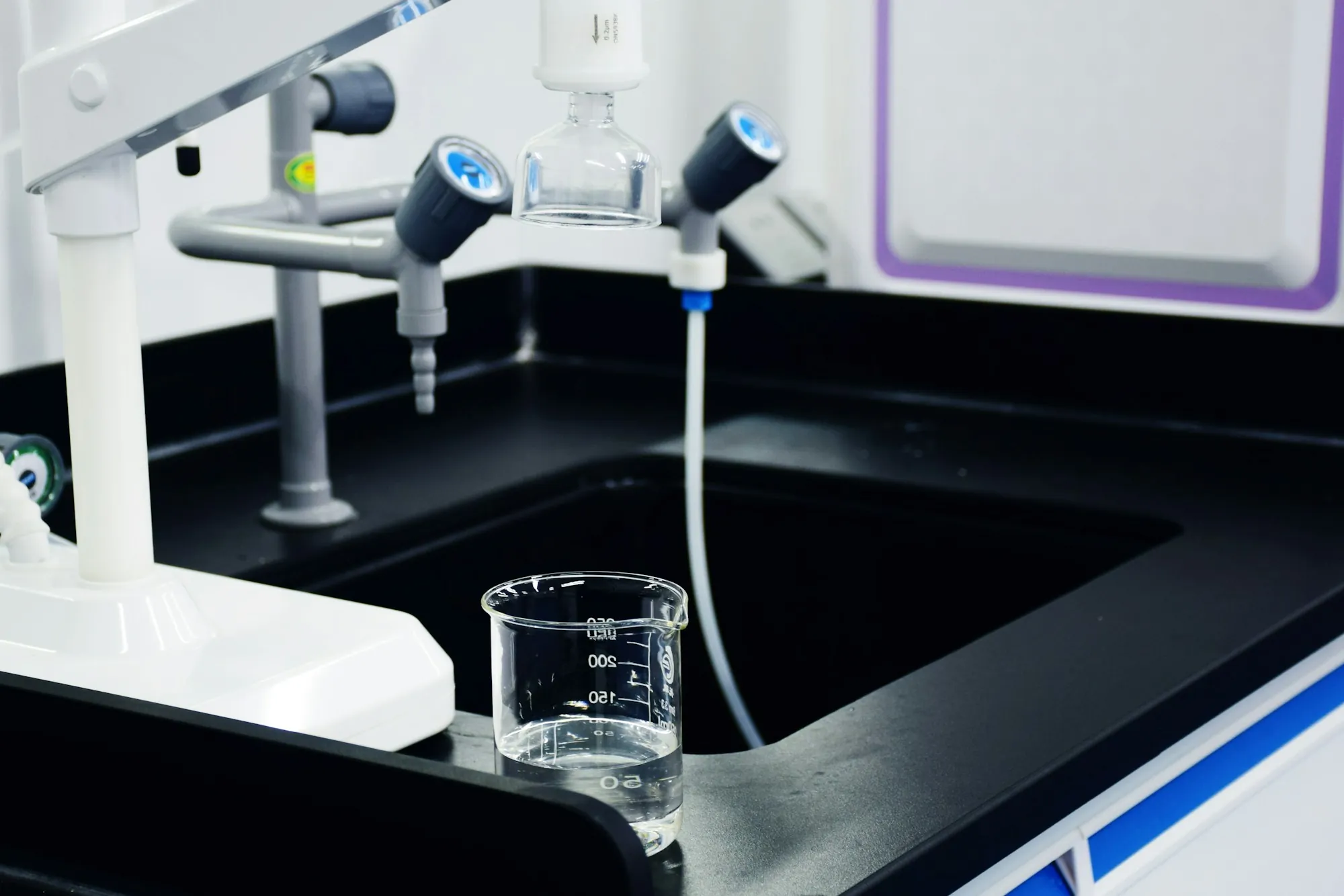 Water Testing & Analysis in Newport Beach Glass beaker filling at a laboratory sink