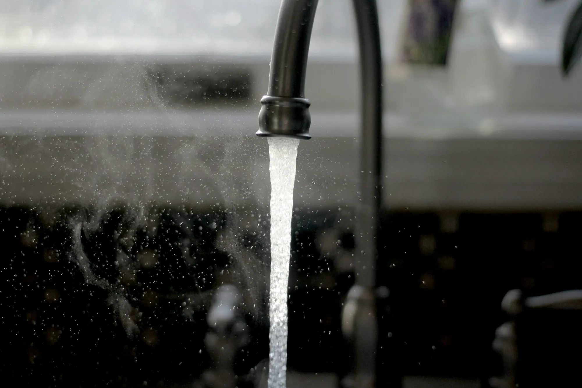 Carbon Filtration Systems in Newport Beach Kitchen faucet running a stream of water