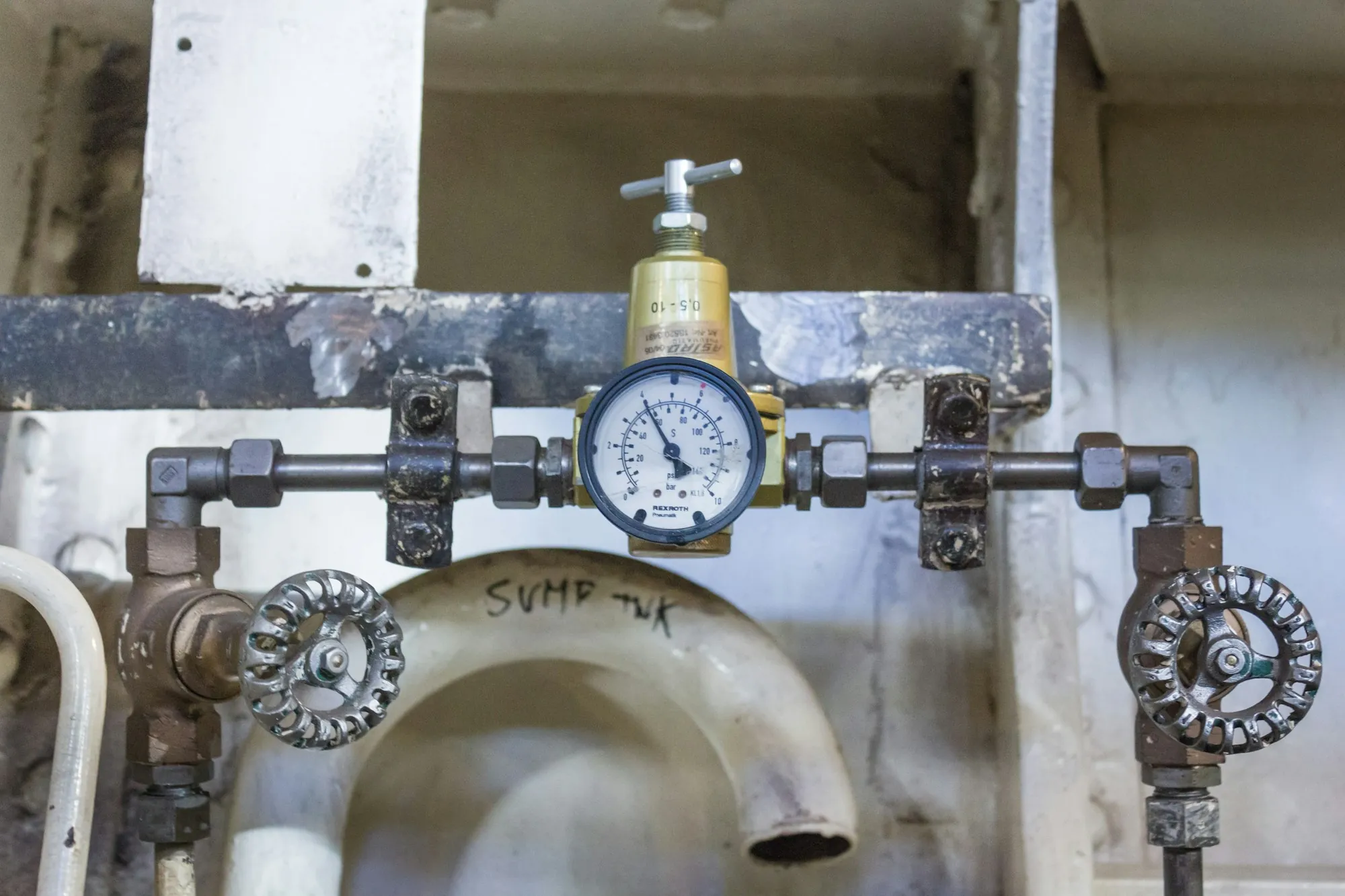 Whole-House Water Filtration in Newport Beach Main water line with shut-off valves and a pressure gauge