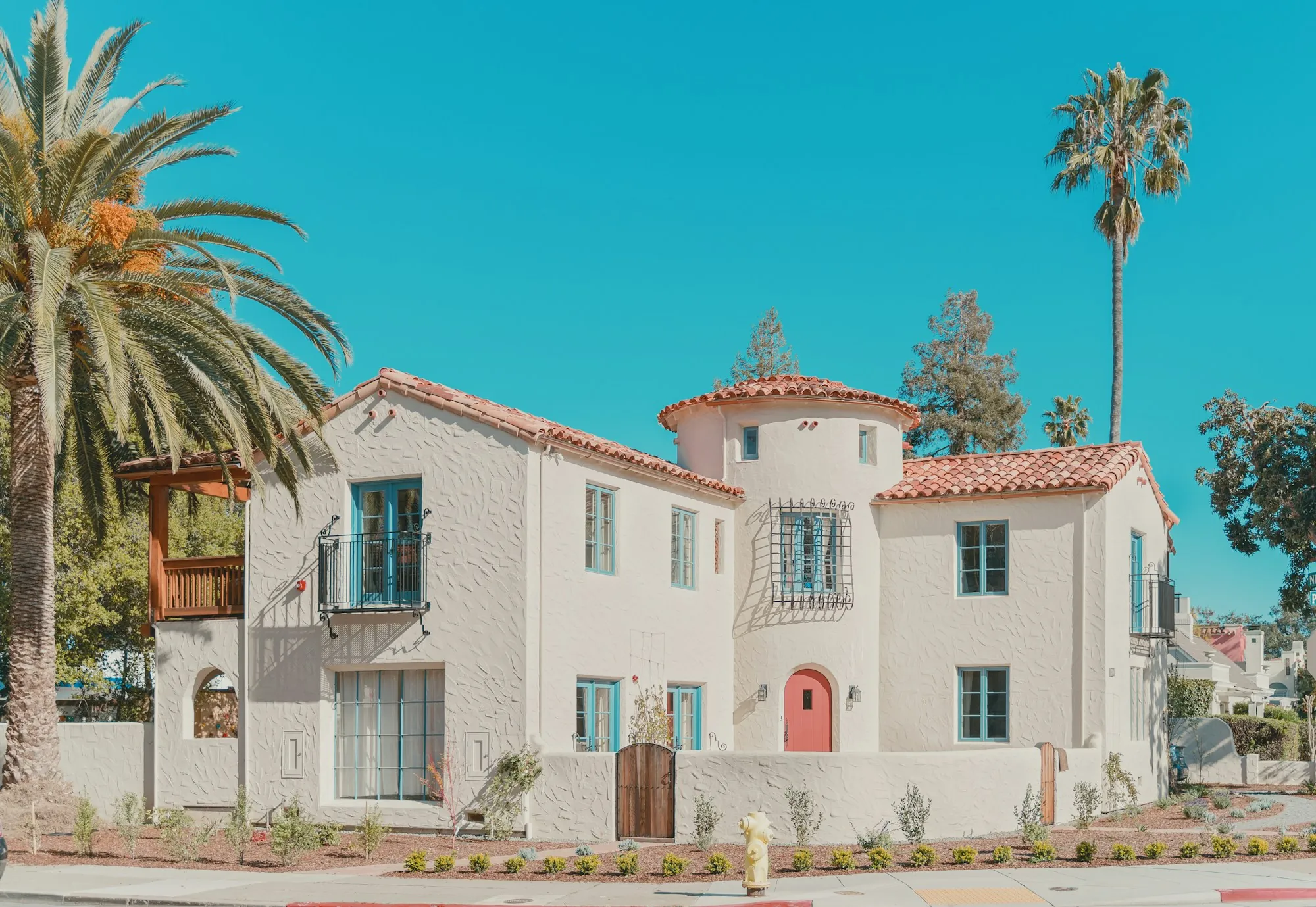 About Newport Beach Water Systems White Spanish-style house framed by palm trees