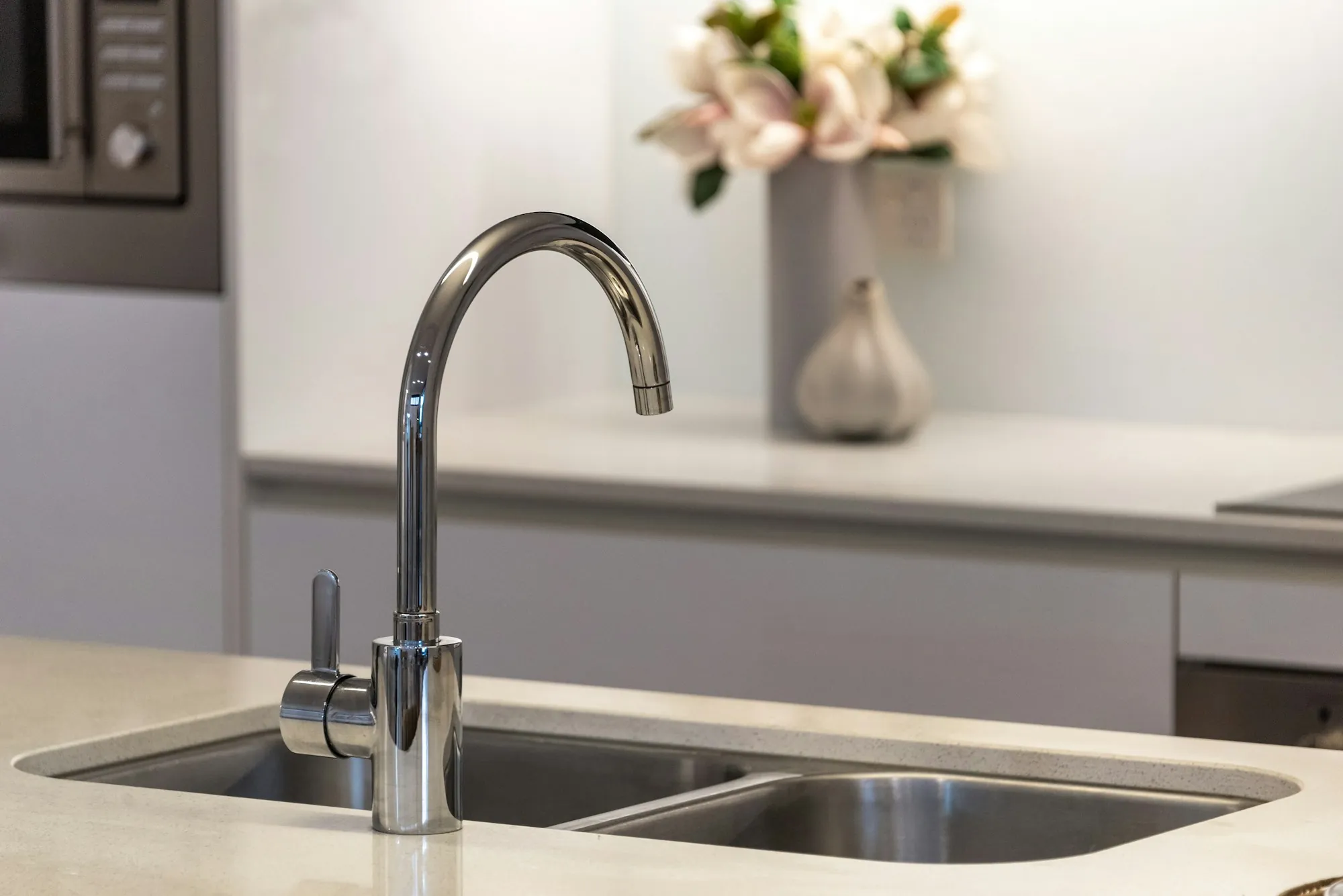 Water Filtration in Newport Beach Built on Testing, Not Sales Pressure Stainless steel faucet over a double kitchen sink