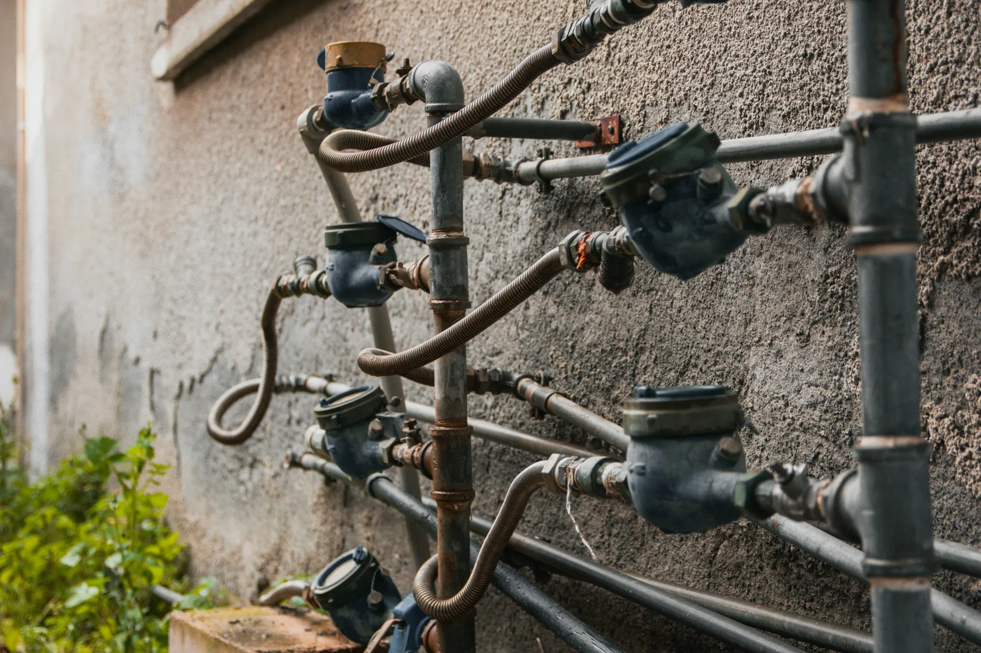 Sediment Filtration in Newport Beach Water meters and pipes mounted on an outside wall