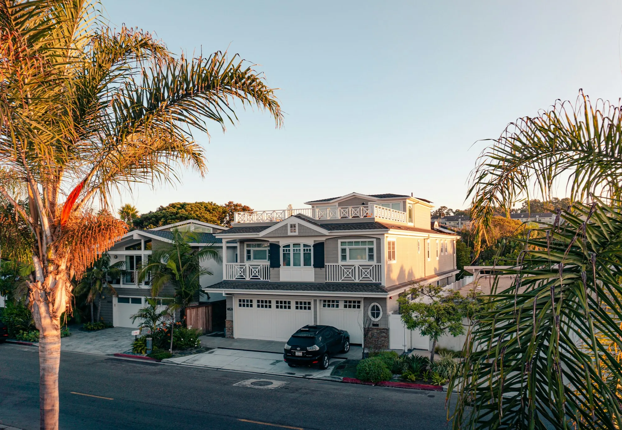 Contact Newport Beach Water Systems Two-story white house on a palm-lined street