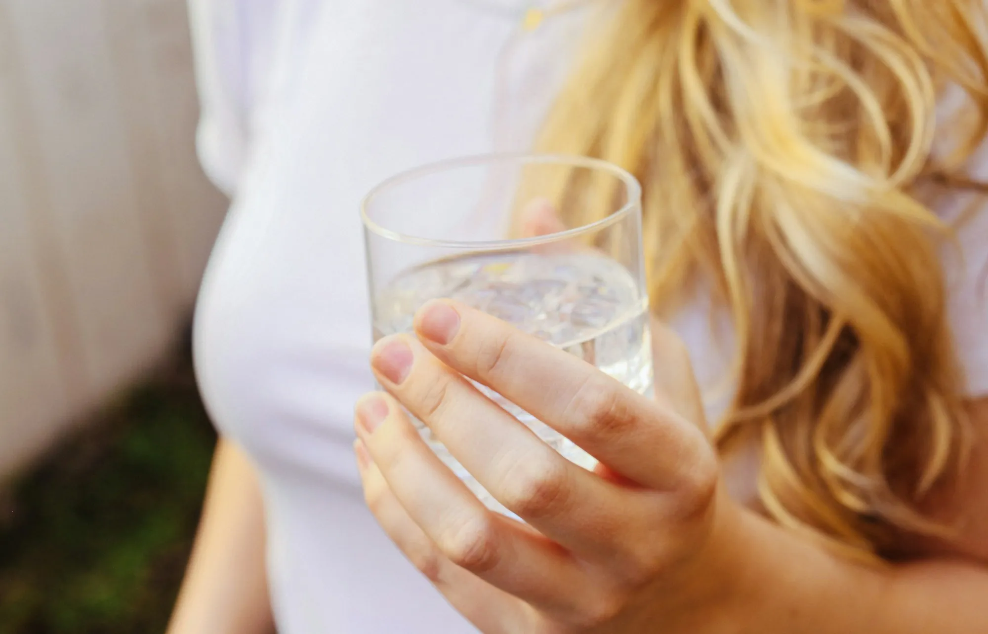 Woman holding a glass of drinking water